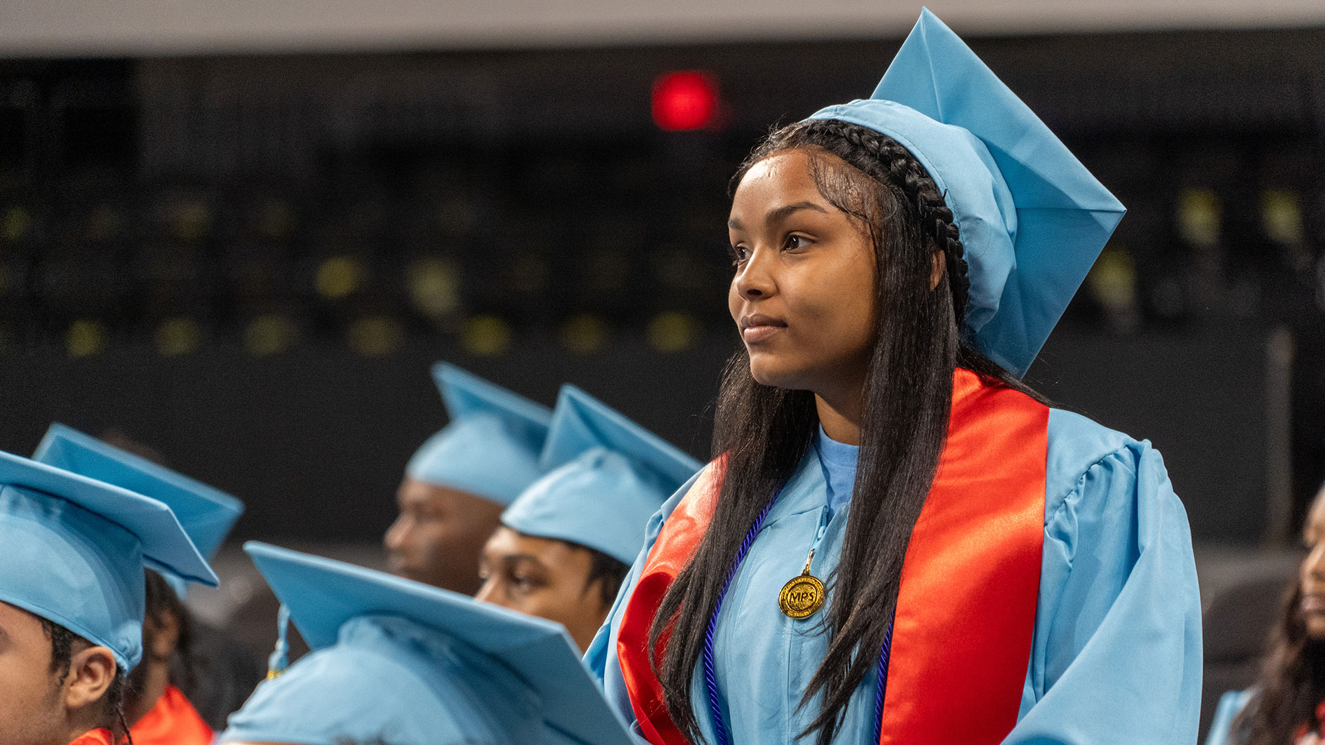 A graduate stands in recognition.