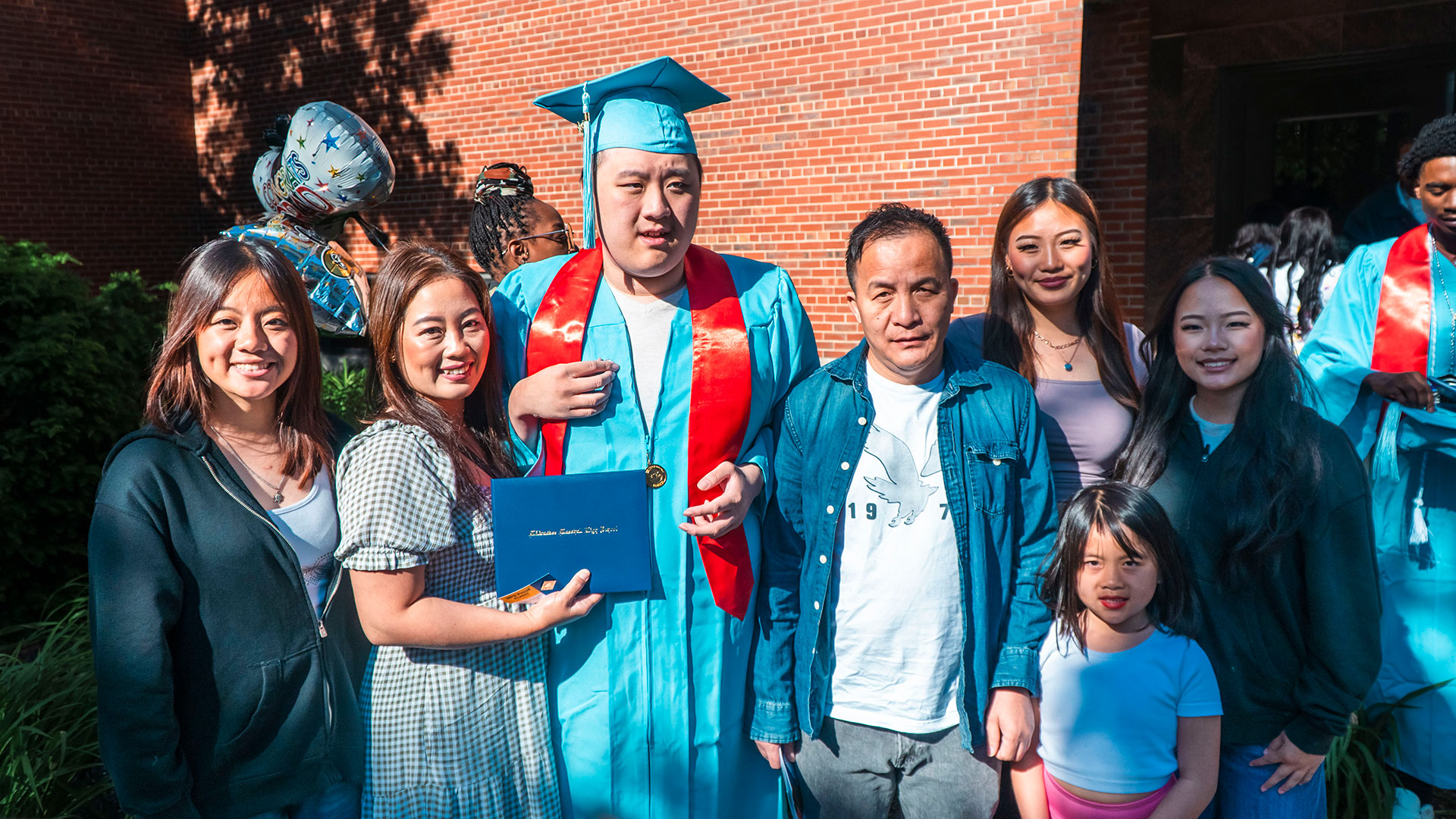 Graduates celebrate outside after the ceremony with their families.