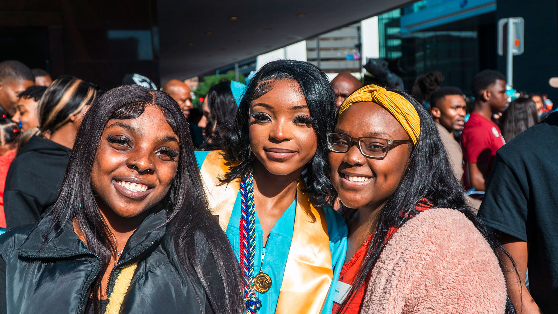 Graduates celebrate outside after the ceremony with their families.