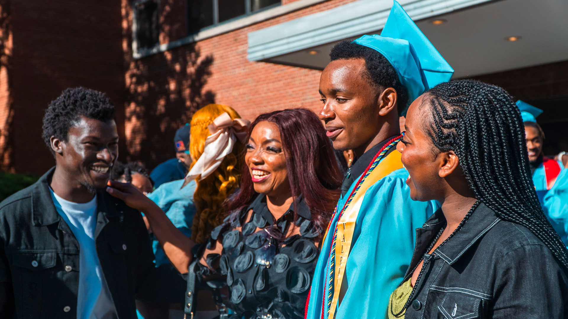 Graduates celebrate outside after the ceremony with their families.