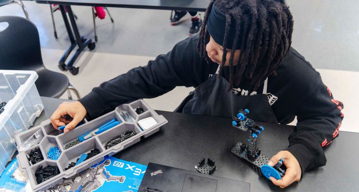 A student assembles an engineering project.
