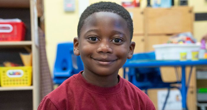 Close-up of a young boy smiling.