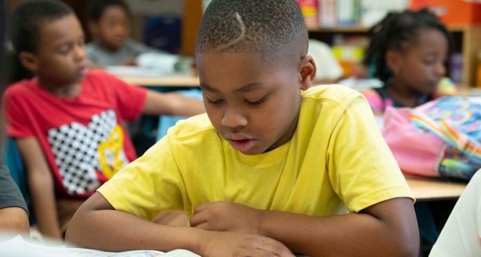 Students in a classroom reading.
