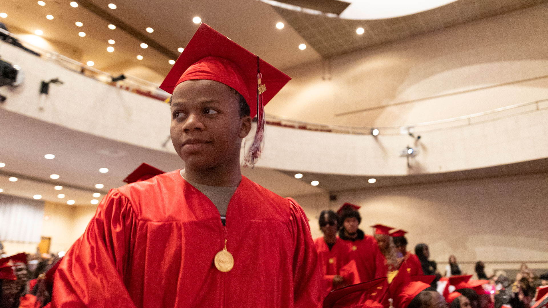 A graduate readies to walk to the stage.
