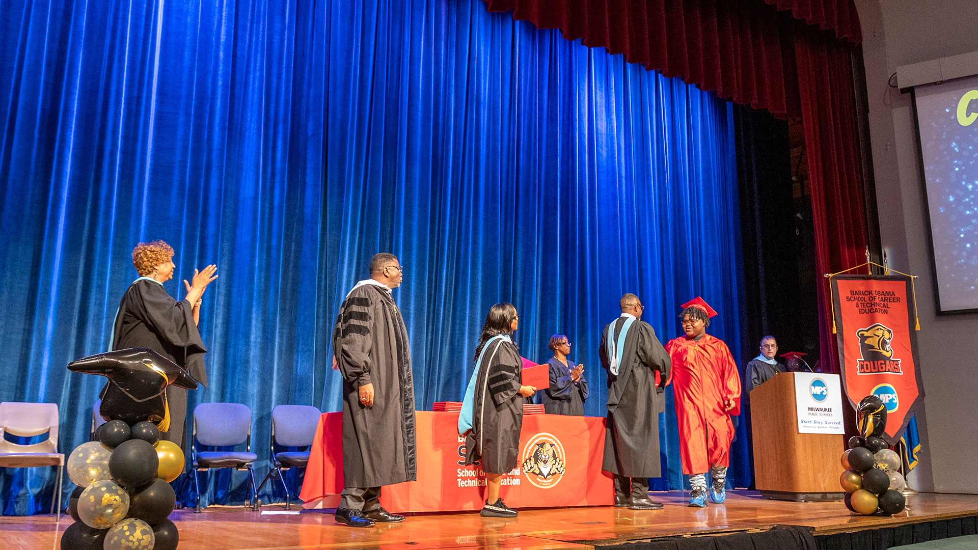 A graduate receives their diploma.