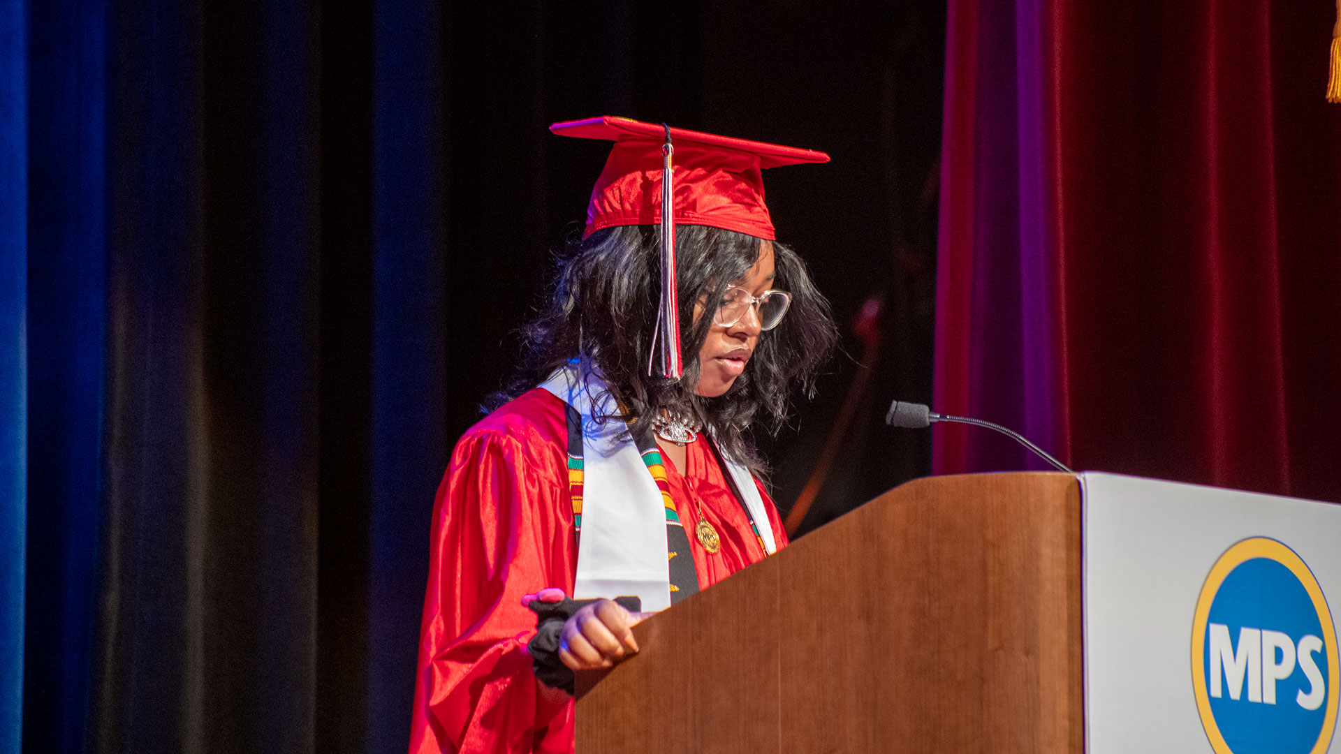 A graduate speaks at the podium.