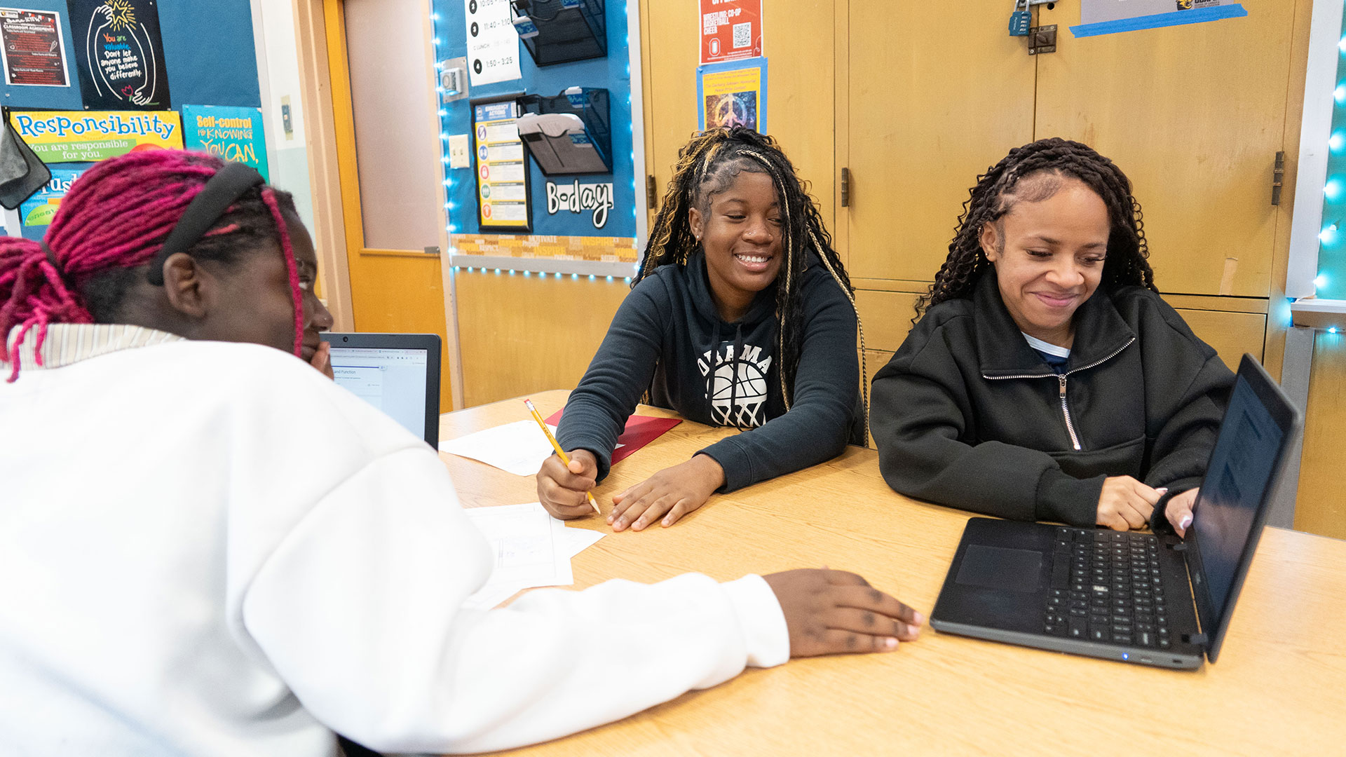 Girls in a classroom using a computer.