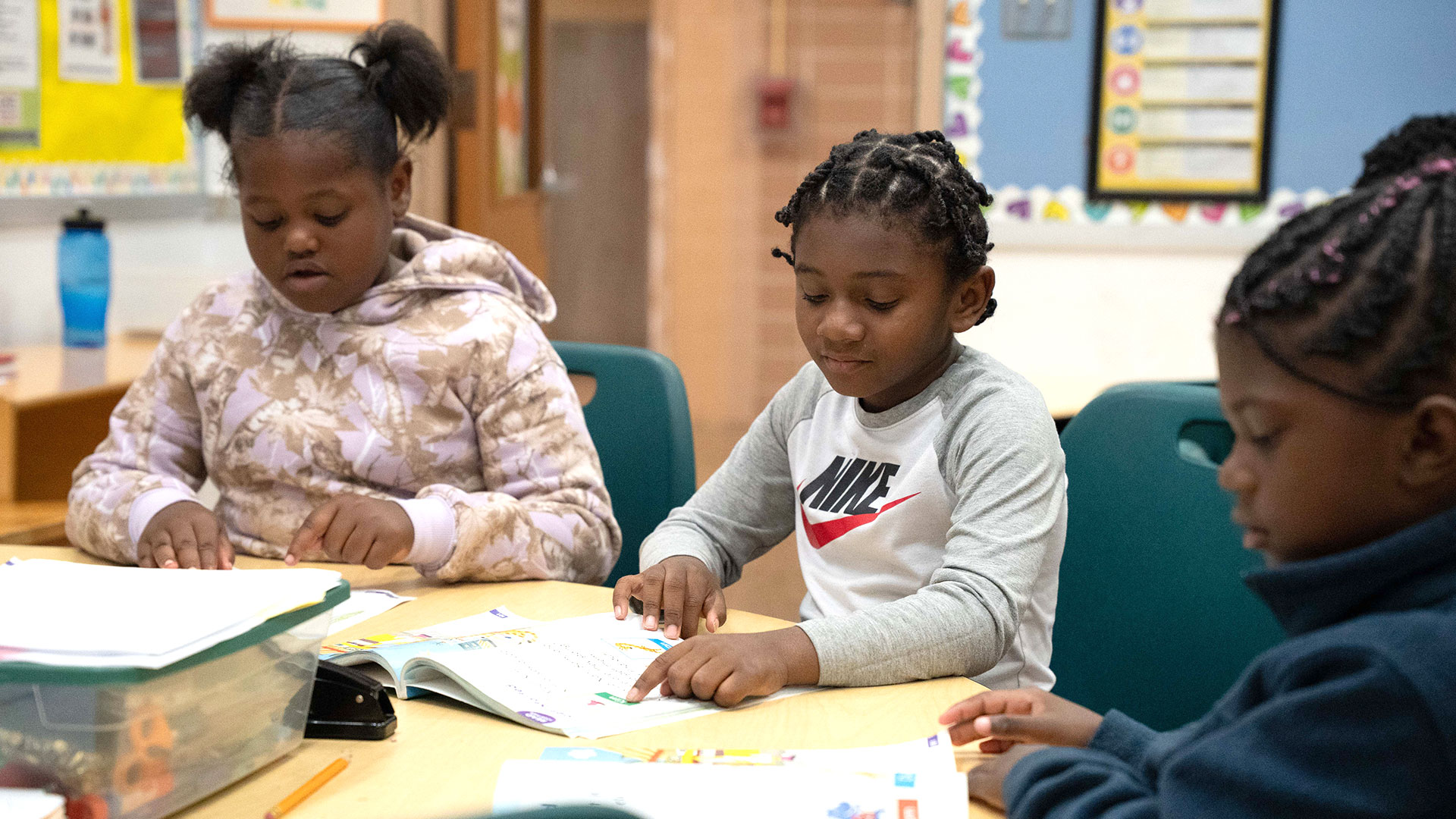 Children at a table in a classroom.
