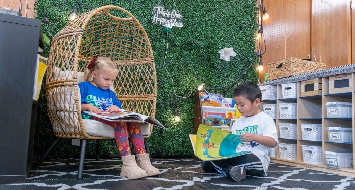 Young children look at picture books.