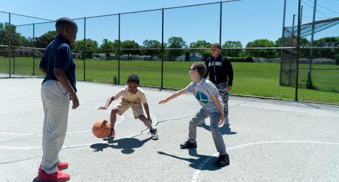 Young boys playing basketball.
