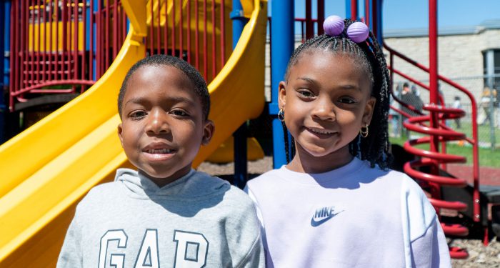 Two young children on a playground.