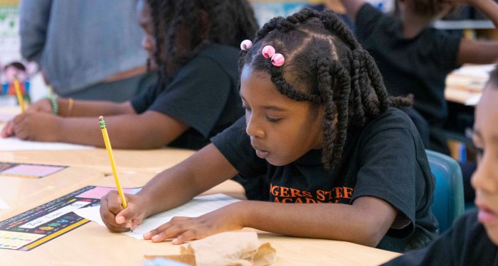 Students at desks working on homework.