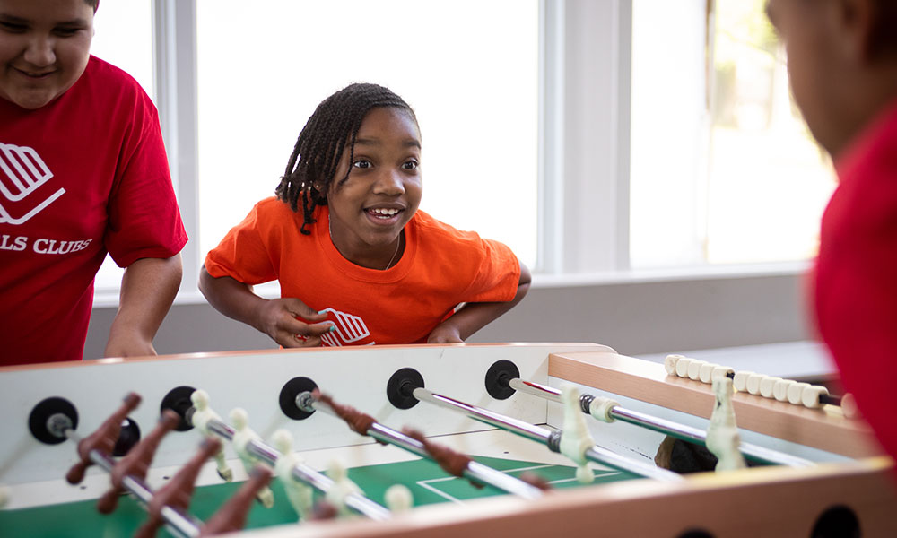 Kids playing foosball