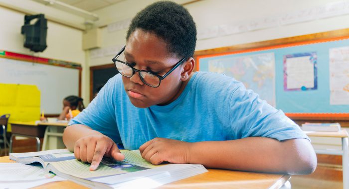 A student concentrates as they read.