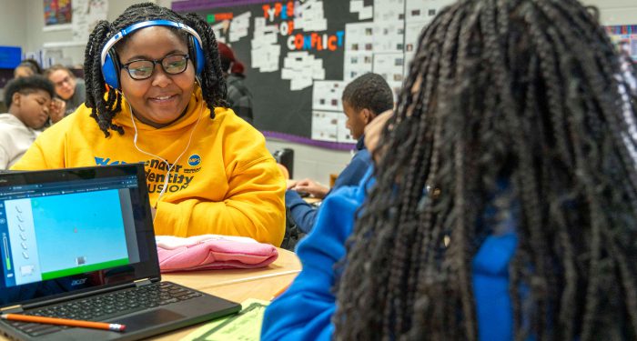 Kids in a classroom using computers.