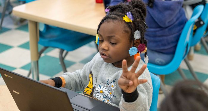 A young child using a computer.