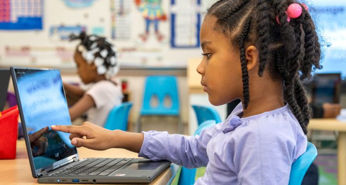 A young child using a computer.