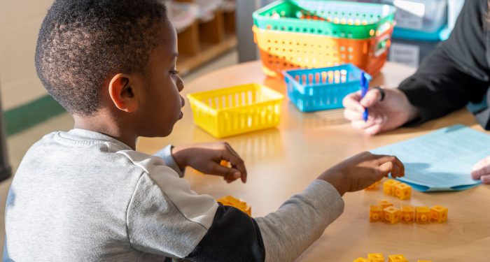 A child counting blocks.