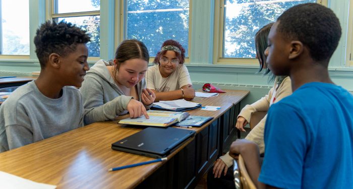 A group of students chatting at a table.