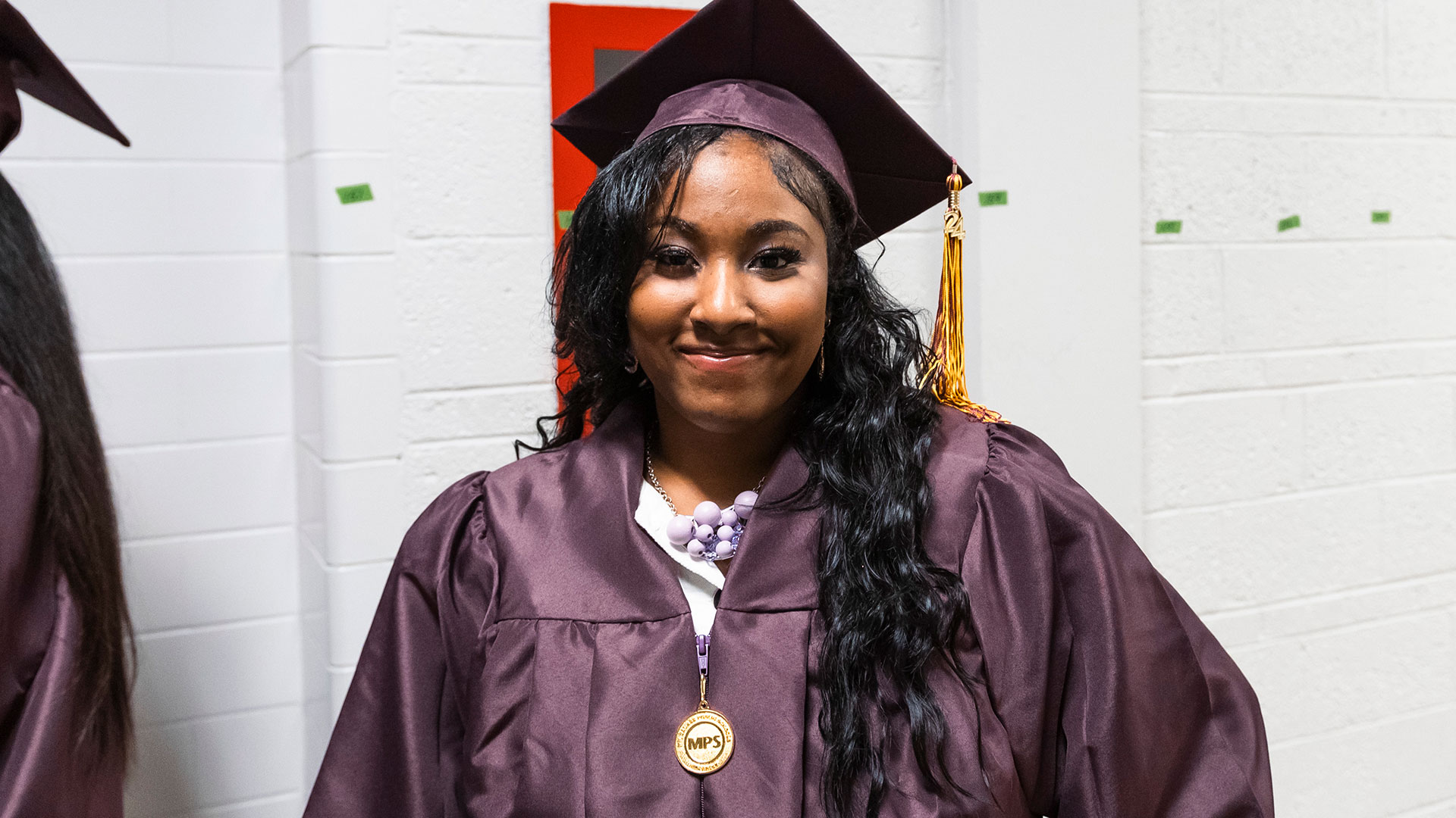 Graduates waiting in the hallway before the ceremony.