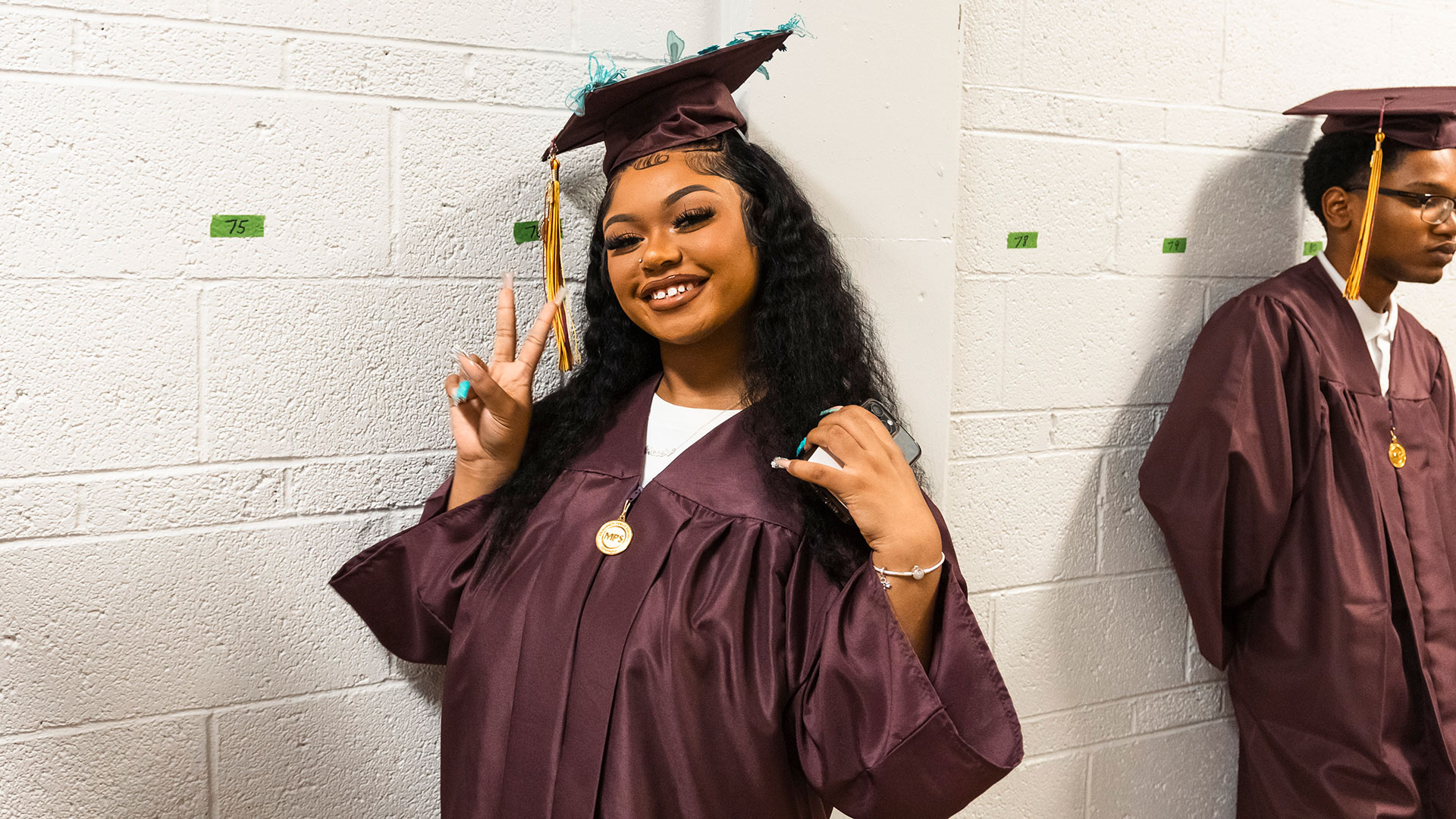 Graduates waiting in the hallway before the ceremony.