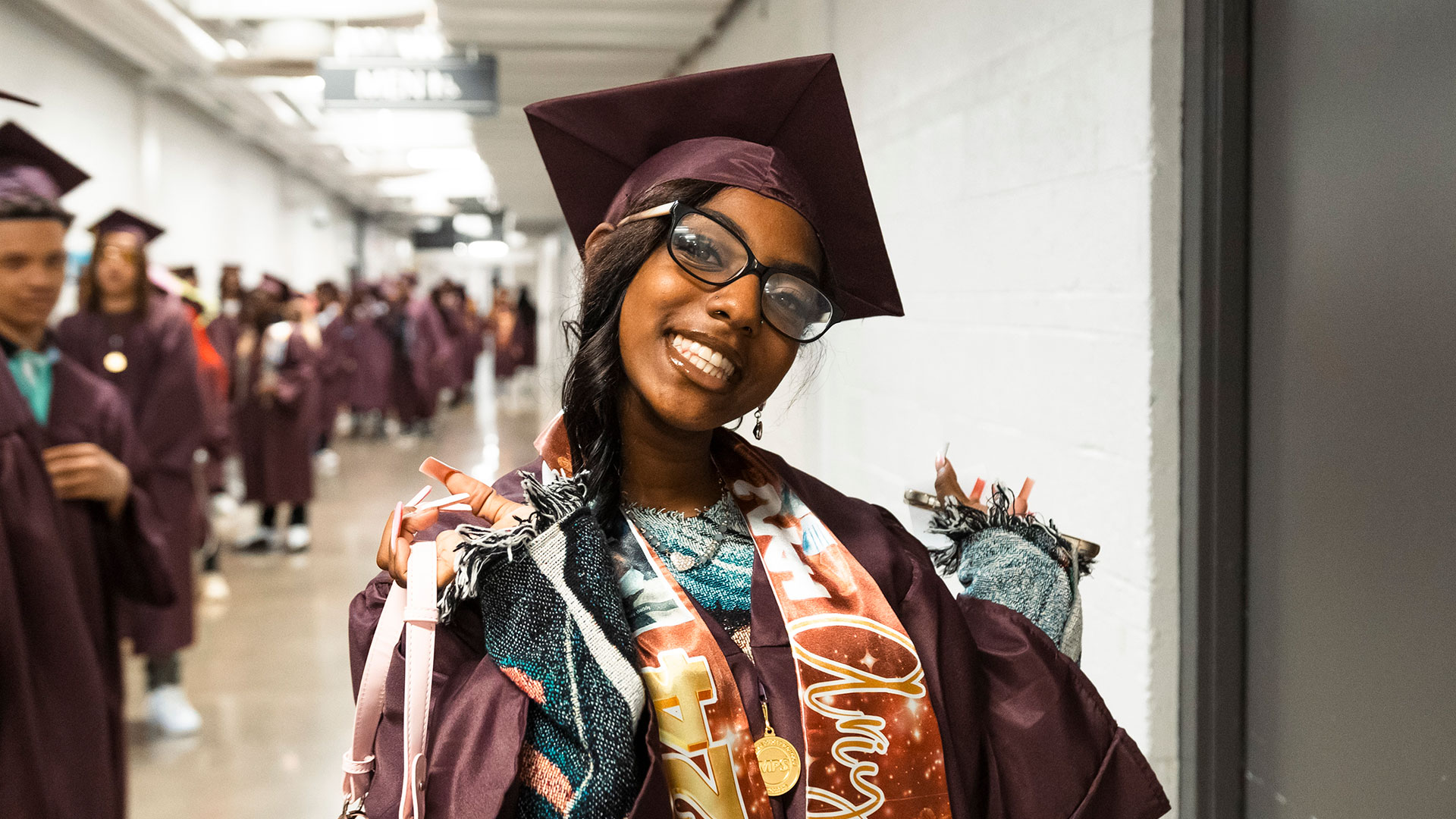 Graduates waiting in the hallway before the ceremony.