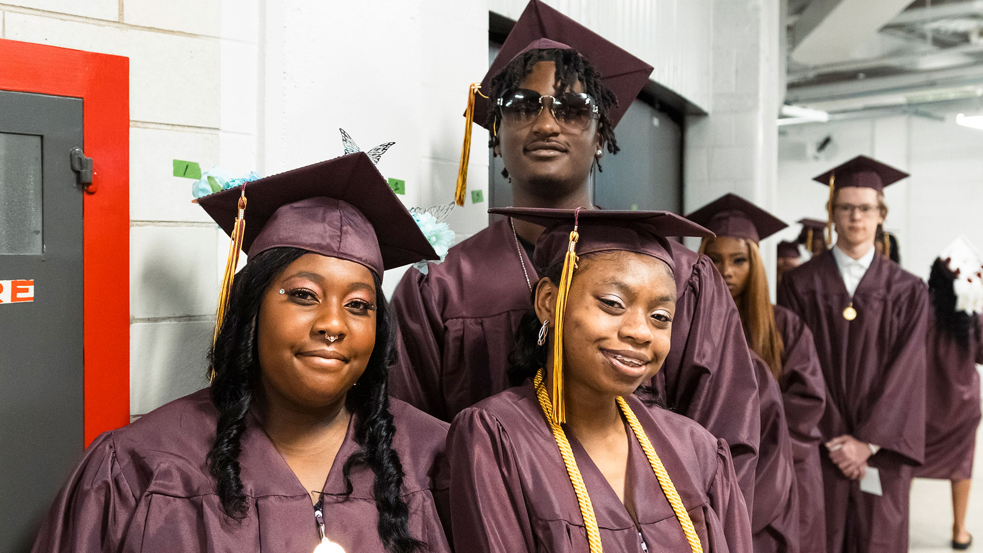 Graduates waiting in the hallway before the ceremony.