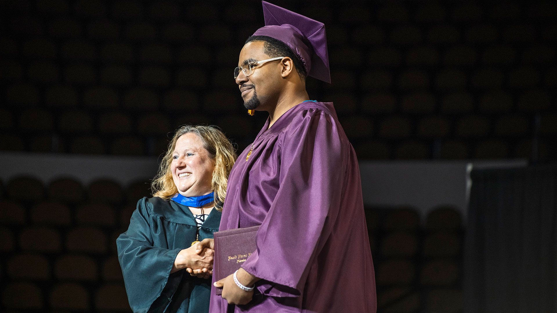 A graduate receiving their diploma.
