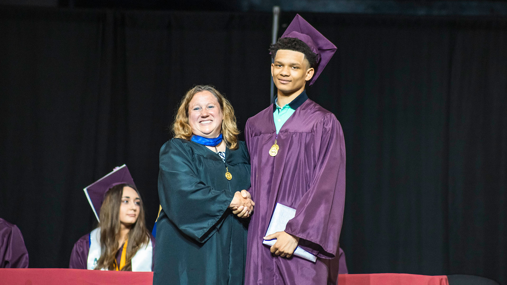 A graduate receiving their diploma.