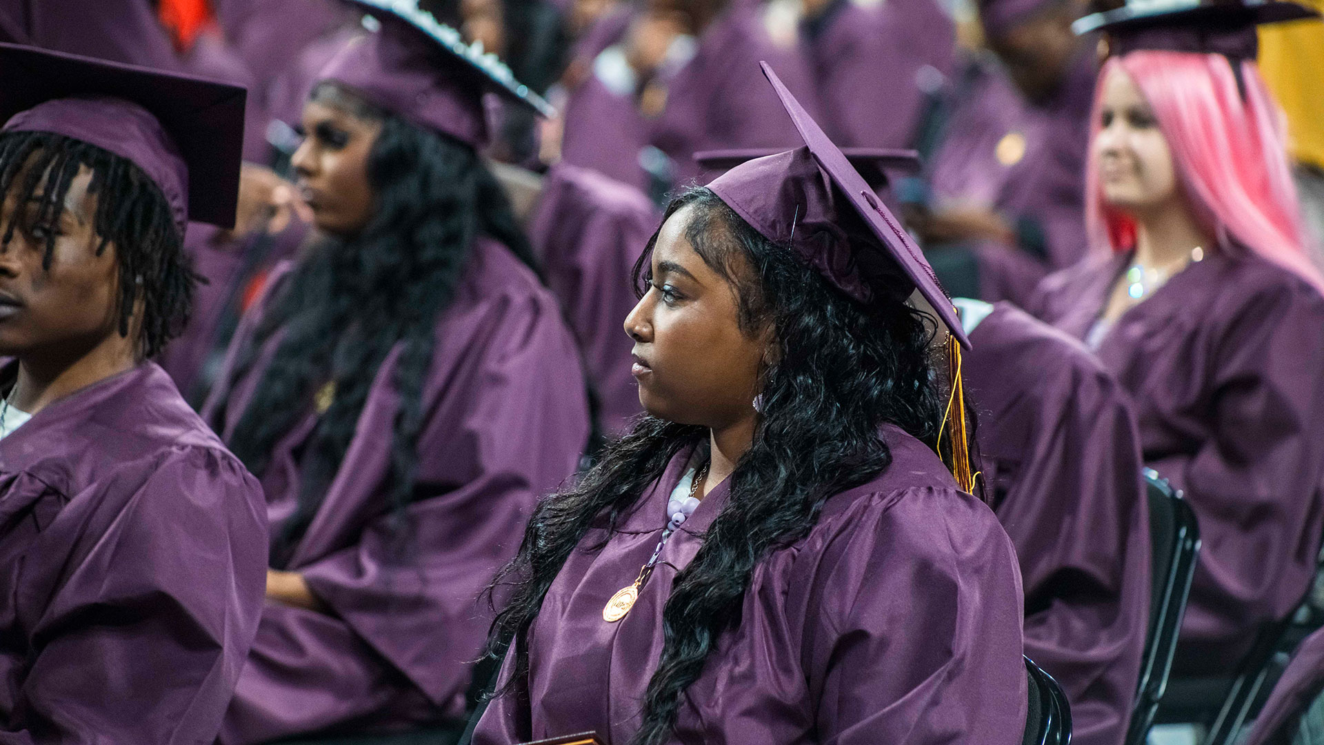 Graduates listening to speeches.