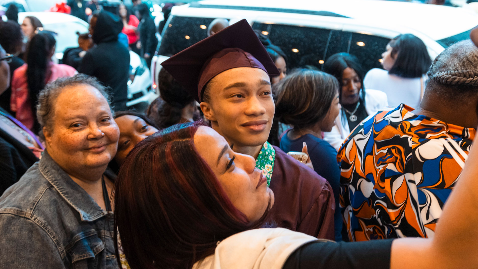 Graduates outside with their families after the ceremony.