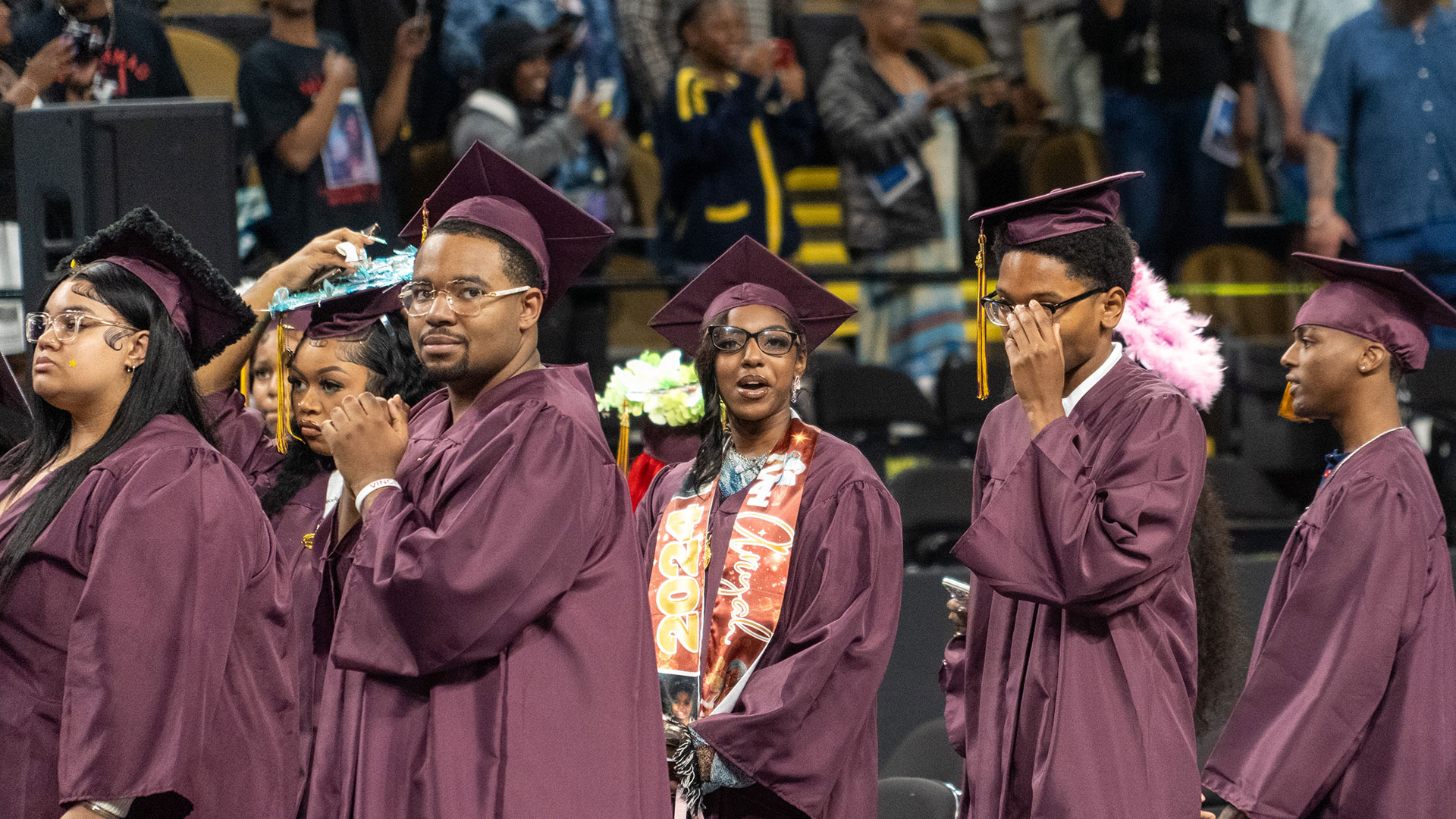 Graduates smiling during the ceremony.