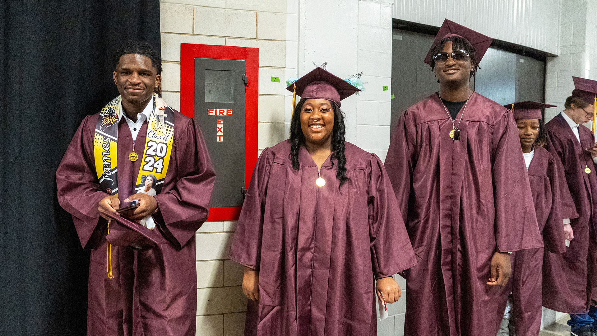 Graduates waiting in the hallway before the ceremony.
