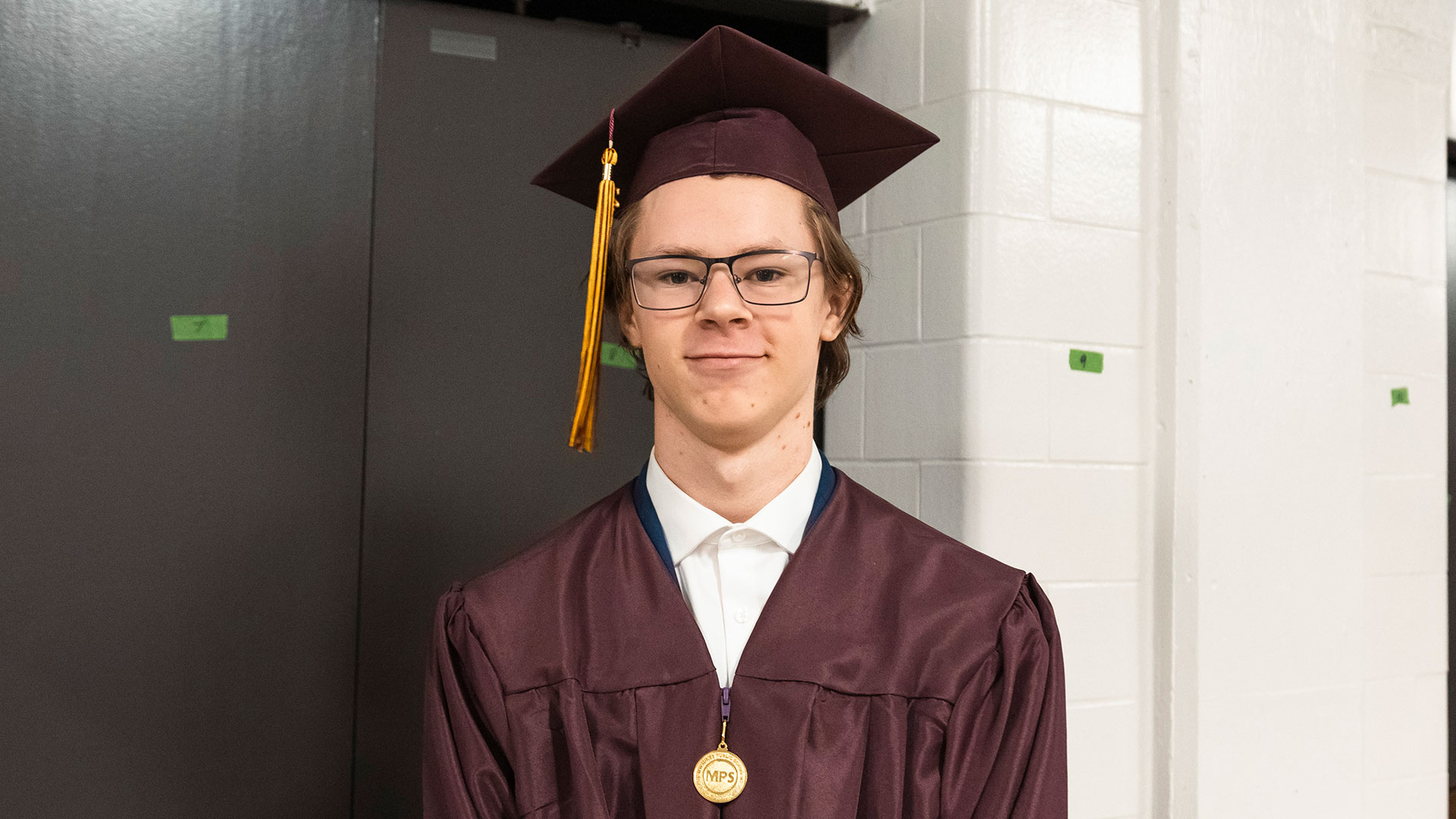 Graduates waiting in the hallway before the ceremony.