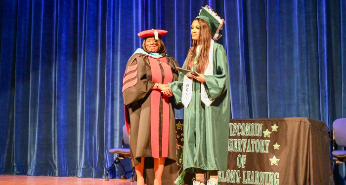 A graduate receiving their diploma.