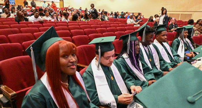 Graduates in an auditorium.