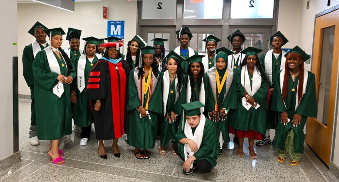 Graduates and staff waiting in the hall before the ceremony.