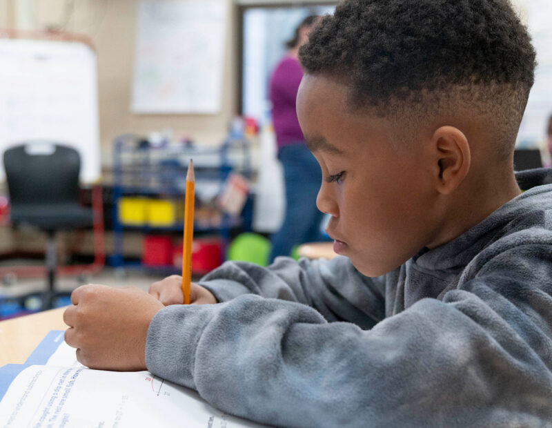 A young student in a classroom.