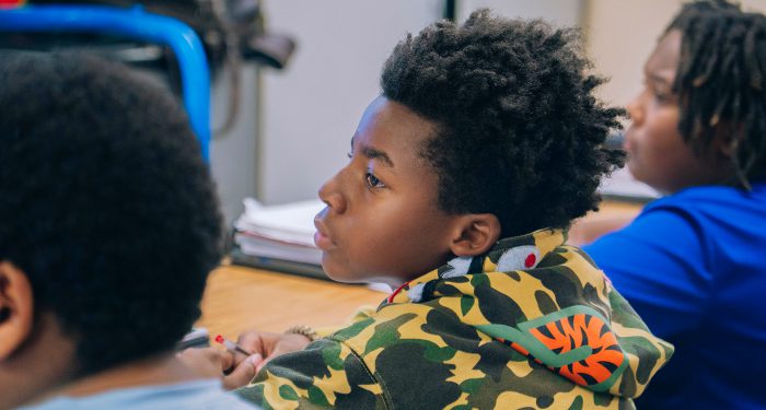 Students in a classroom looking to the front of the room.